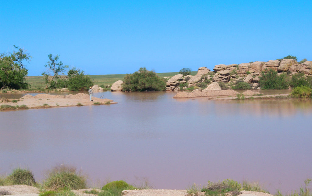 Shallow dirt tank - water reservoir - on Twin Buttes Ranch